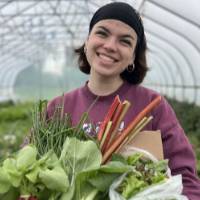 One of the SAP interns poses with one of the first full shares available during the early spring.